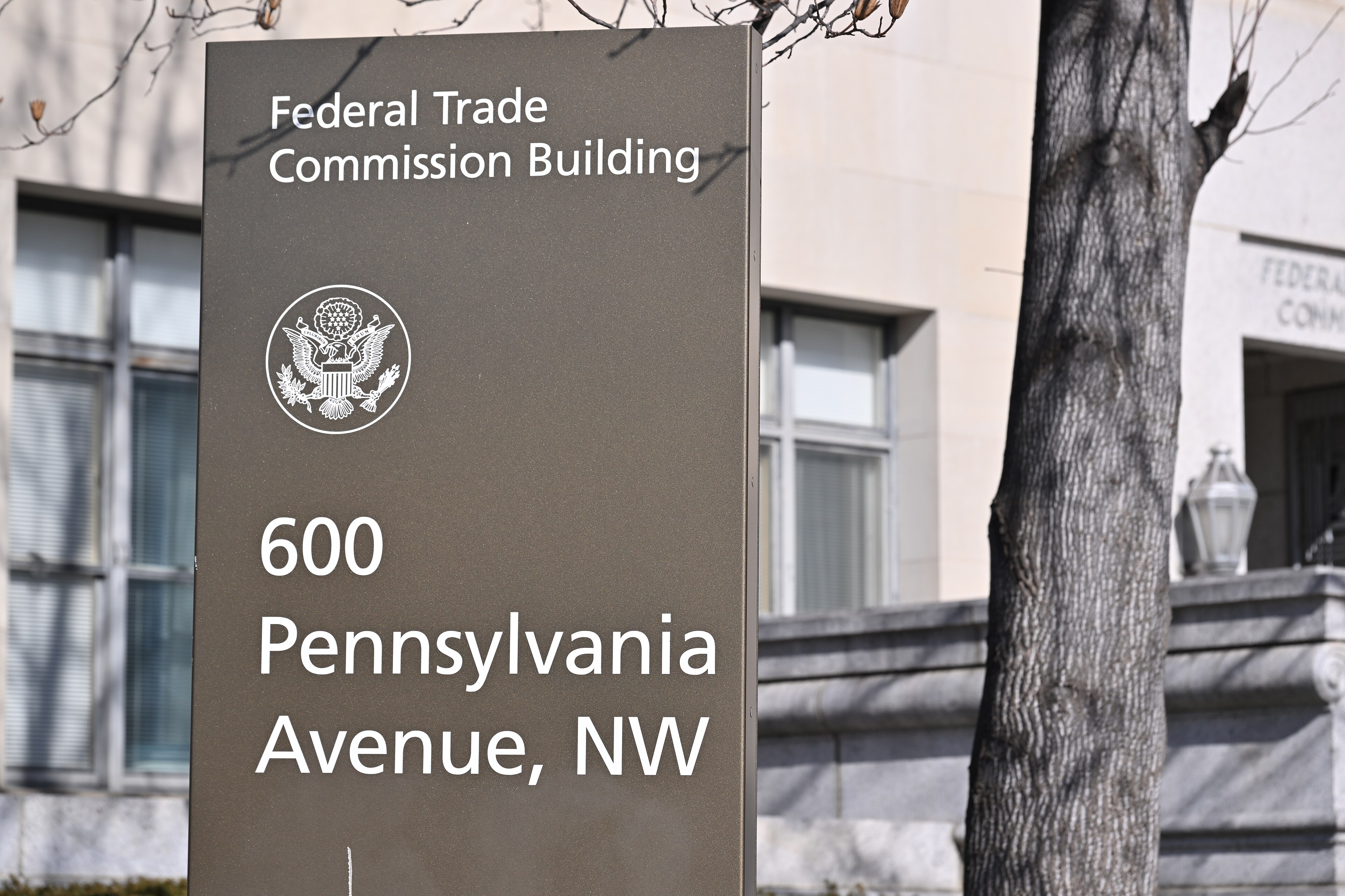 Federal Trade Commission Building sign at 600 Pennsylvania Avenue in Washington, with the agency building behind it.