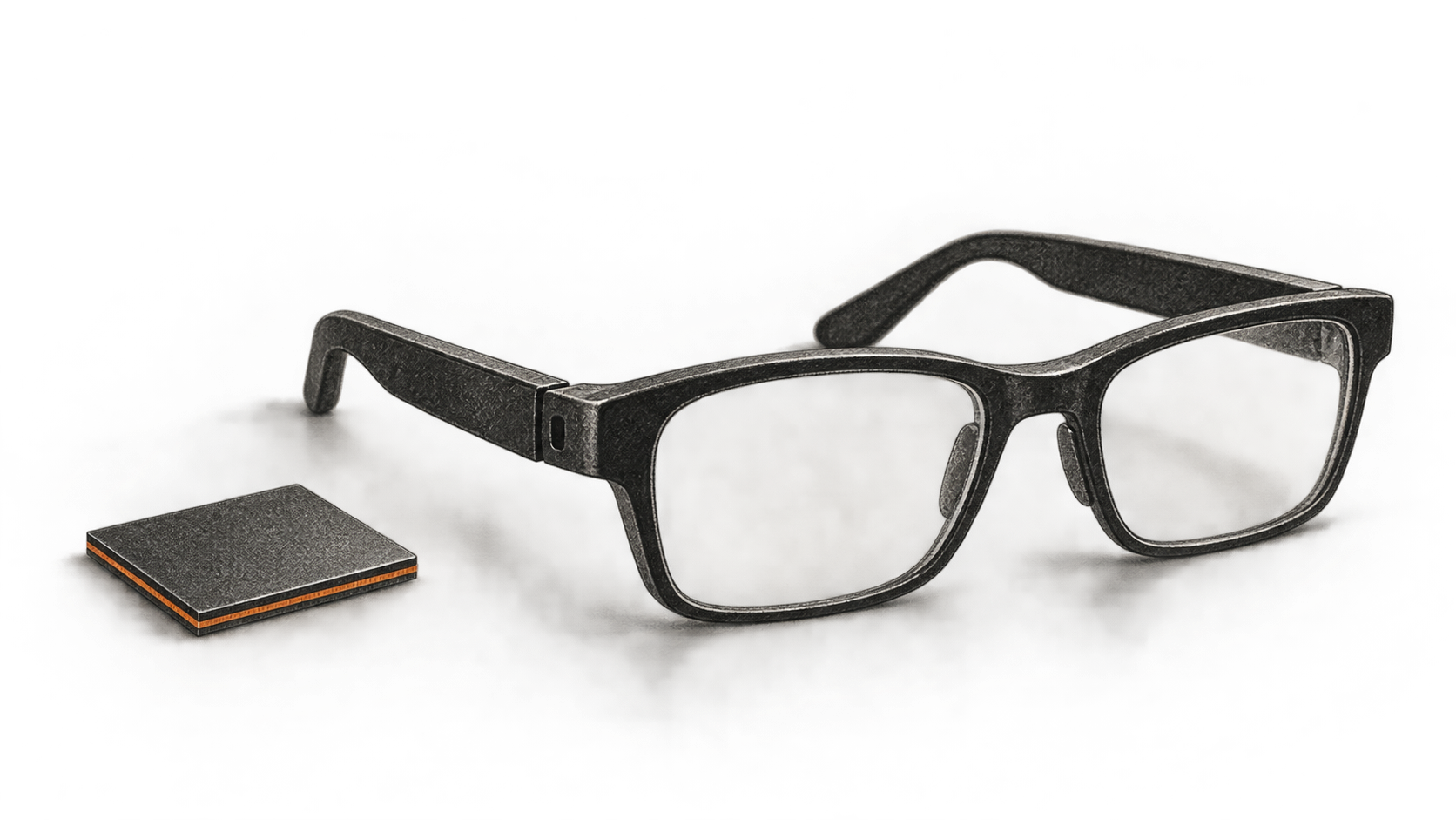 A generic pair of black eyeglasses rests beside a small square processor package on a plain surface.